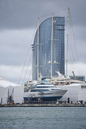 Barcelona, Spain - 24 Nov, 2021: Superyachts and boats in sailing in Barcelona shipyard with the hotel W in the backgroundのeditorial素材
