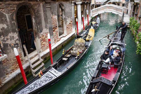 Venice, Italy - Nov 14, 2022: Traditional Gondolas navigate the narrow canals of Veniceのeditorial素材