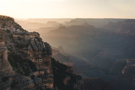 Silhouette of man on cliff during sunset at Grand Canyon National Park, view from south rim, Arizona, USAの写真素材