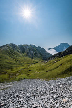 Scenic panoramic view of idyllic alpine mountain peak landscape on a beautiful sunny day with blue sky in summerの写真素材