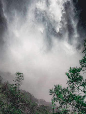 Close up of water flowing from Upper Yosemite Falls smashing on the rock walls, Yosemite National Park, Californiaの写真素材