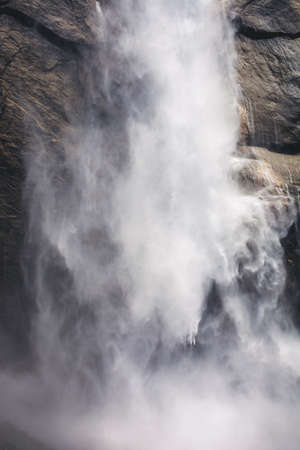 Close up of water flowing from Upper Yosemite Falls smashing on the rock walls, Yosemite National Park, Californiaの写真素材
