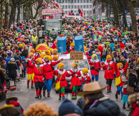 Aachen, Germany - February 12, 2018: The Aachen Rose Monday procession in the carnival. People in traditional costume throwing candyのeditorial素材