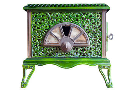 Old indoor wood burner with a decorative pattern scratches and dents from use on an isolated white background with a clipping pathの写真素材