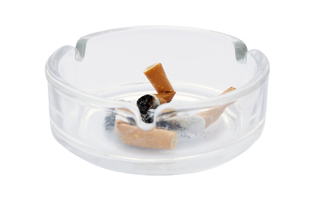Ash tray with burnt out cigarette butts on an isolated white background with a clipping pathの写真素材
