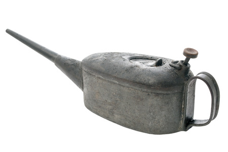 Vintage oil container coated in grease and dust from years of use on an isolated white background with a clipping pathの写真素材