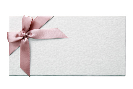 White gift box decorated with a pink bow on an isolated white backgroundの写真素材