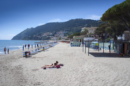 Laigueglia, Liguria, Italy - May 3, 2010: Laigueglia Mediterranean sandy beach  front on a hot summer dayのeditorial素材