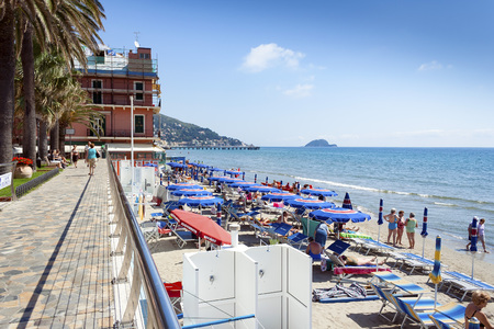 Alassio, Liguria, Italy - May 19, 2009: People sunbathing and relaxing on the beach at Alassio Italy on a warm summer day with a clear blue skyのeditorial素材