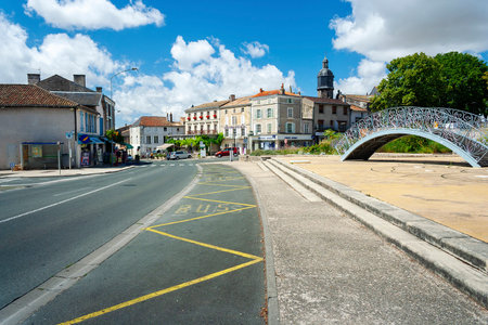 Melle, Deux-Sevres, France - July 6, 2011: Road through Melle in France with decorative bridge on a...