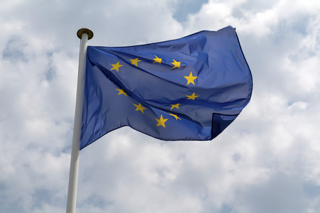 European Union flag flying against a cloudy skyの写真素材