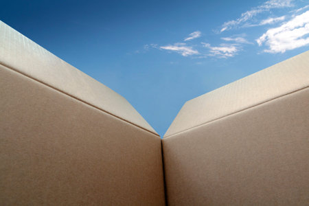 Think outside the box looking outwards to a clear blue sky with a few fluffy white clouds with copy...