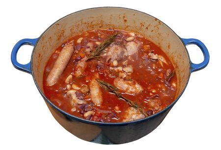 Chicken, sausage, beans and bacon cassoulet in a large blue pan on an isolated whiteの写真素材