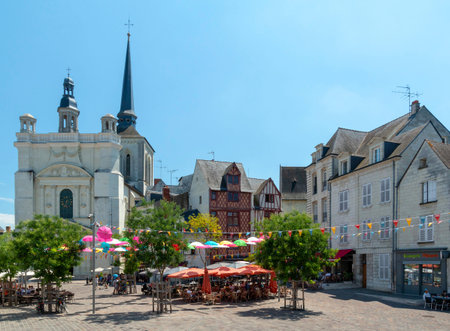 Saumur, Pays de la Loire, France - July 1, 2018: Busy square Place Saint-Pierre in Saumur with people dinning at outdoor restaurant seating areasのeditorial素材