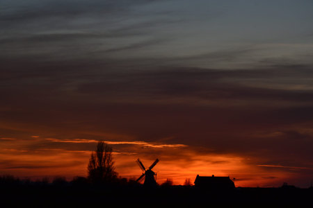 Evening Landscape with windmill and train tracks, near Visvliet, Groningen. The Netherlandsの写真素材