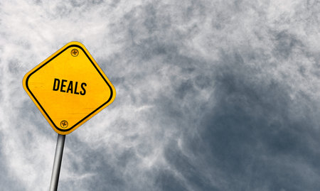 deals - yellow sign with cloudy sky