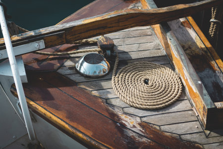Front view of a wooden boat deck with a rope lying on it, backgroundの写真素材