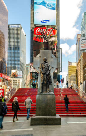 Duffy Square Monument with red Staircase at Time Square New York, People walking on the stairs, low angle view during daytime, verticalのeditorial素材
