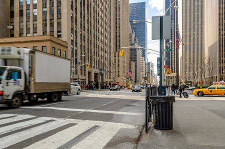 Manhattan New York City, Street near Radio City Music Hall with lots of traffic, crosswalk and trash...