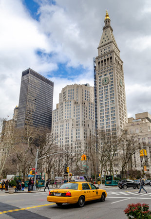 Met Life Tower during daylight, New York City with yellow taxi cab in the forefront, low angle view,...