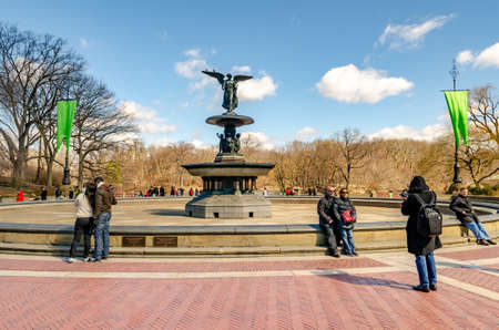 Bethesda Fountain with Angel of the Waters Sculpture, front view, Central Park New York during winter, people standing and walking around the fountain, clear sky, horizontalのeditorial素材