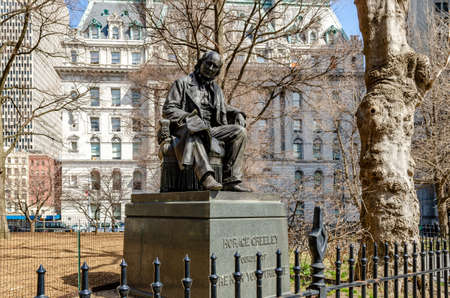 Statue Monument of Horace Greeley, New York City, low angle front view during daytime in Winter, horizontalのeditorial素材