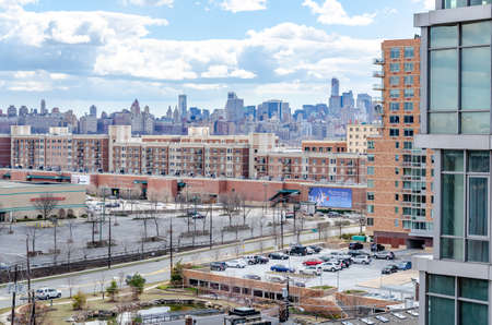 Manhattan Skyline with office buildings and parking lot of Cliffside Park New Jersey in the front during a sunny winter day, horizontalのeditorial素材