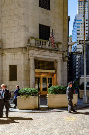 New York Stock Exchange golden colored Building Entrance with Security in suits standing in front, verticalのeditorial素材