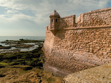 Old castle walls in Cadiz, Spain during cloudy skyのeditorial素材