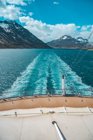 Rear view from a cruise ship on a fjord near Seydisfjordur, Iceland, vertical shotの写真素材