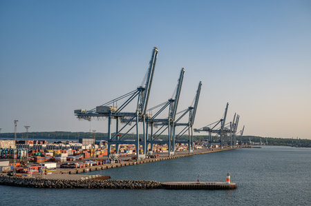 Blue freight cranes at the Port of Aarhus, Denmark during sunsetの写真素材