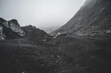 Gray sand landscape next to Solheimajokull Glacier during rainy weather, Iceland