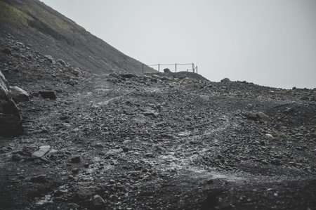 Gray rocky landscape near viewpoint at Solheimajokull Glacier during rainy weather, Icelandの写真素材