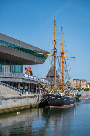 Old traditional Sailship sailboat in front of Aarhus Stadsarkiv, Denmark, vertical shotの写真素材