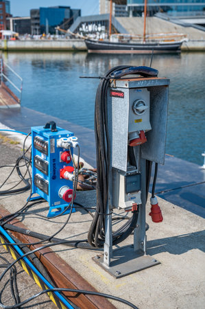 Close-up electricity cables charging station at the port harbor of Aarhus, vertical shot