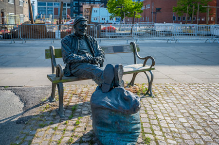 Old fisherman statue monument sitting on a bench at the Port Harbor of Aarhus, Denmarkのeditorial素材
