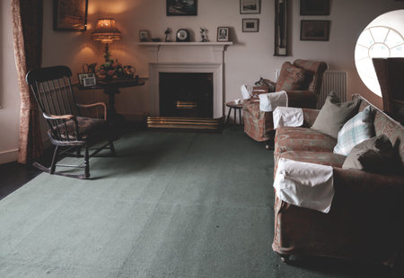 living room with couch and chimney indoors at Skaill House museum, Orkney Island, Scotland