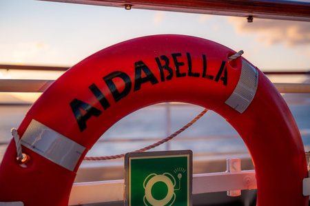 Close-up orange AIDA Bella lifebuoy during sunsetのeditorial素材