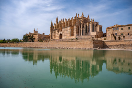 La Seu Cathedral Santa Maria of Palma, Majorca, Spain with lake in front, perfect reflection on water surface during sunset, horizontal shot, Mallorcaのeditorial素材