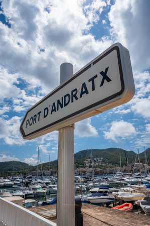 Port Andratx, Mallorca sign at the harbor with ships and yachts in the background, Majorca, low angle vertical shotの写真素材
