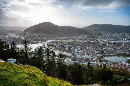 A panoramic view of Bergen nestled between rolling hills and a river, with a mix of modern and traditional architecture, Norwayの写真素材