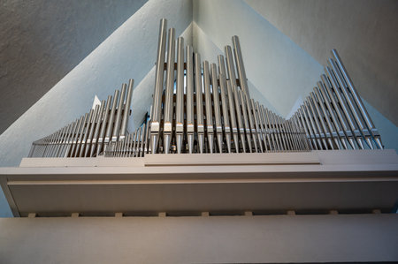 The Arctic Cathedral, Tromso, Norway. large pipe organ with numerous vertical pipes is installed on a balcony above a light-colored wallの写真素材