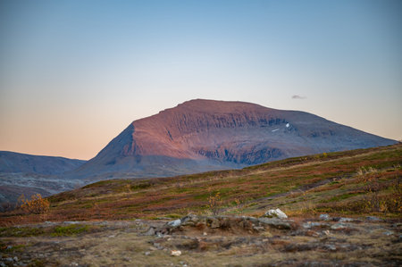 Storsteinen, Tromso, Norway, majestic mountain rises in the distance, bathed in the soft light of...