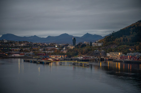 Narvik, Norway, serene harbor town with a cityscape, mountains in the background, and a dock...