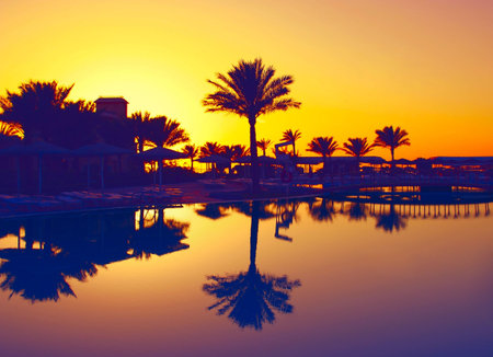 A photography of a pool view with sunset