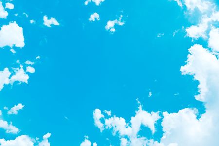 A photography of a blue summer sky with bright white cloudsの写真素材