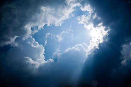 A photography of sun rays and dark clouds