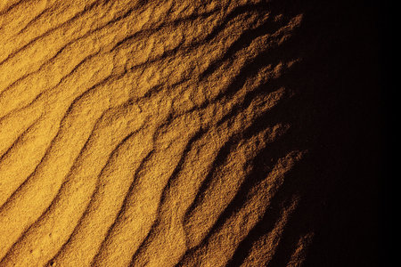 A photography of a sand texture fades to blackの写真素材