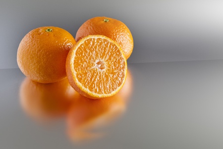 An image of three clementines on greyの写真素材