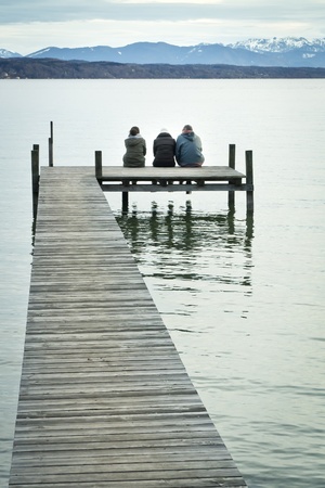 Three at the jetty - Starnberg Lake in Bavaria Germanyの写真素材